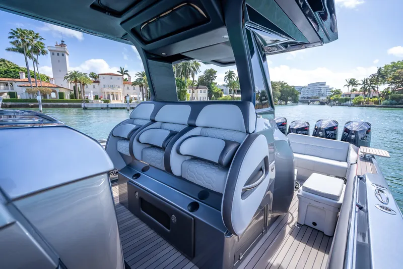 Slide: The Image of 2022 Nor-Tech 500 Sport Center Console boat interior with luxurious seating and multiple outboard engines. - 85
