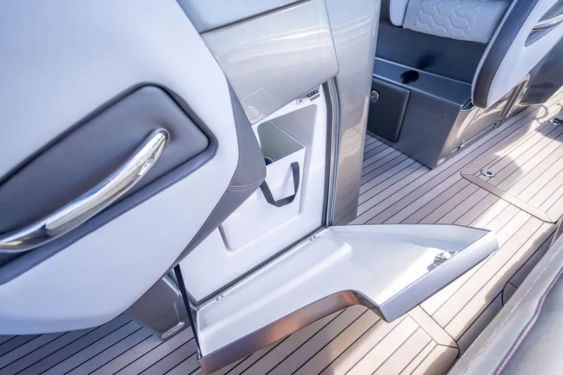 Slide: The Image of 2022 Nor-Tech 500 Sport Center Console interior with open storage compartment. - 86