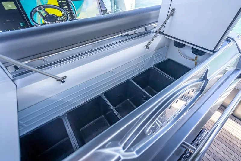Slide: The Image of Open storage compartment on 2022 Nor-Tech 500 Sport Center Console boat. - 87
