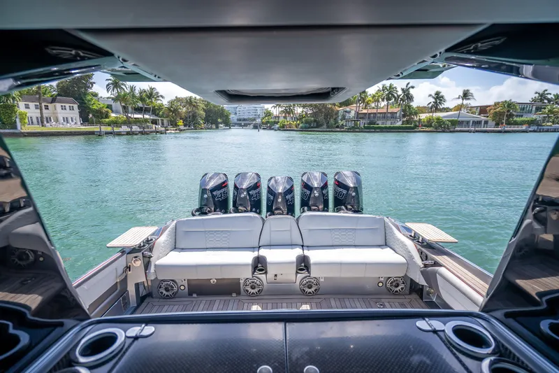 Slide: The Image of 2022 Nor-Tech 500 Sport Center Console boat with multiple engines on a scenic waterway. - 89