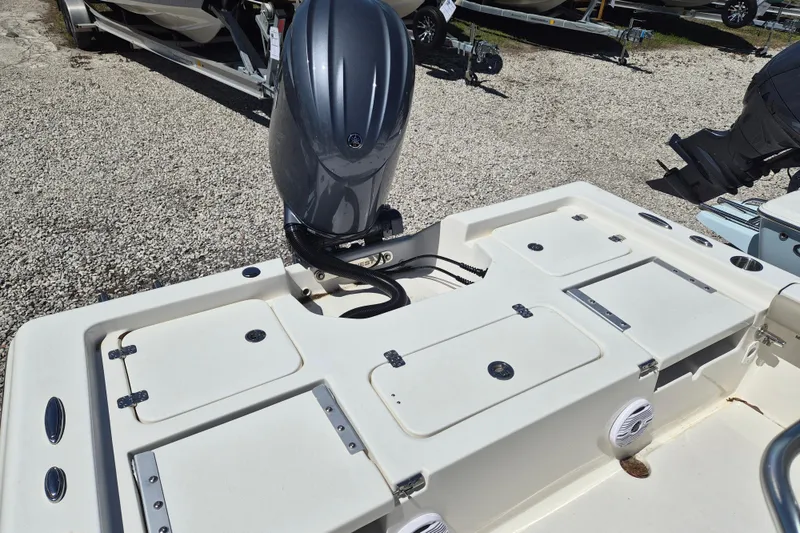 Slide: The Image of 2026 Key West 230 Bay Reef boat with Yamaha outboard motor, open storage compartments. - 3