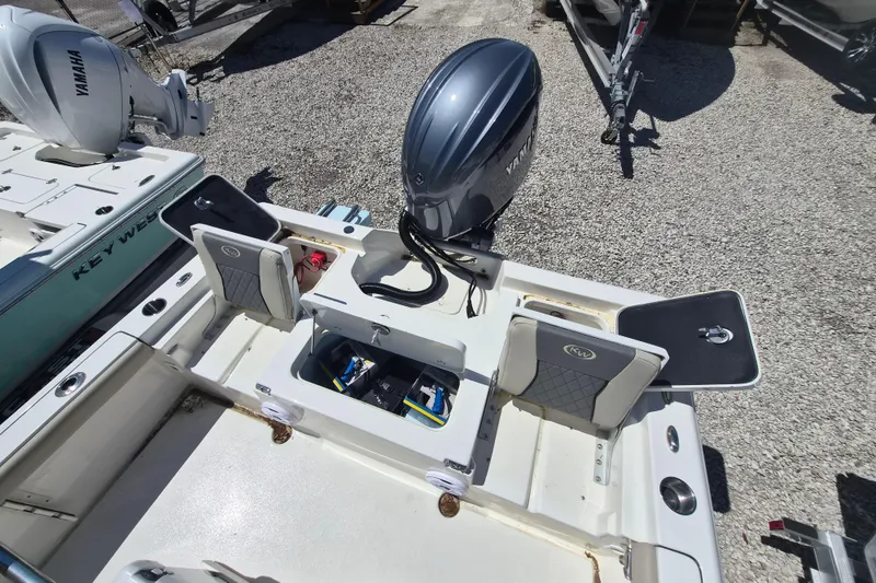 Slide: The Image of 2026 Key West 230 Bay Reef boat interior with steering console and seating. - 4