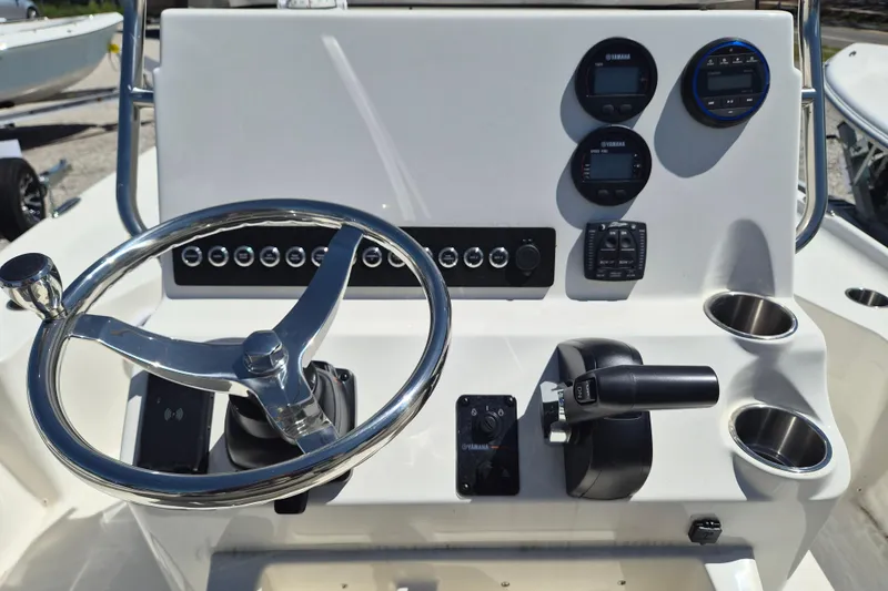 Slide: The Image of 2026 Key West 230 Bay Reef boat console with gauges and compass. - 7