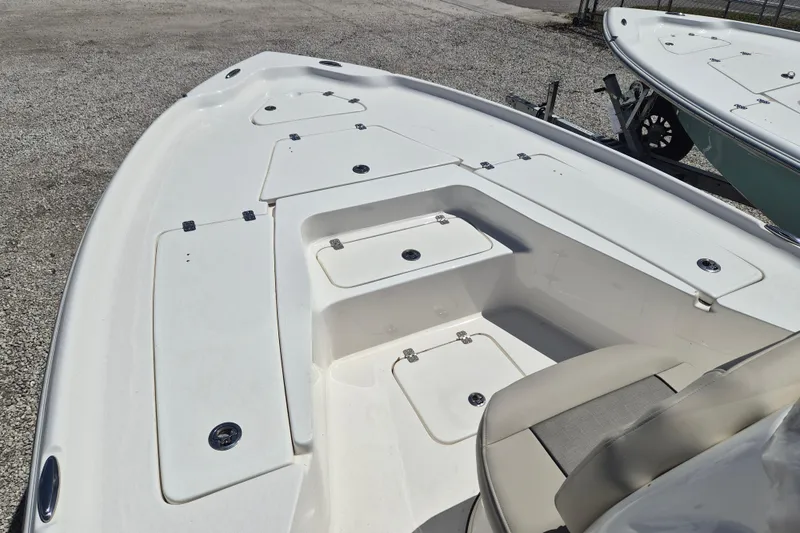 Slide: The Image of 2026 Key West 230 Bay Reef boat with open storage compartments and seating. - 9