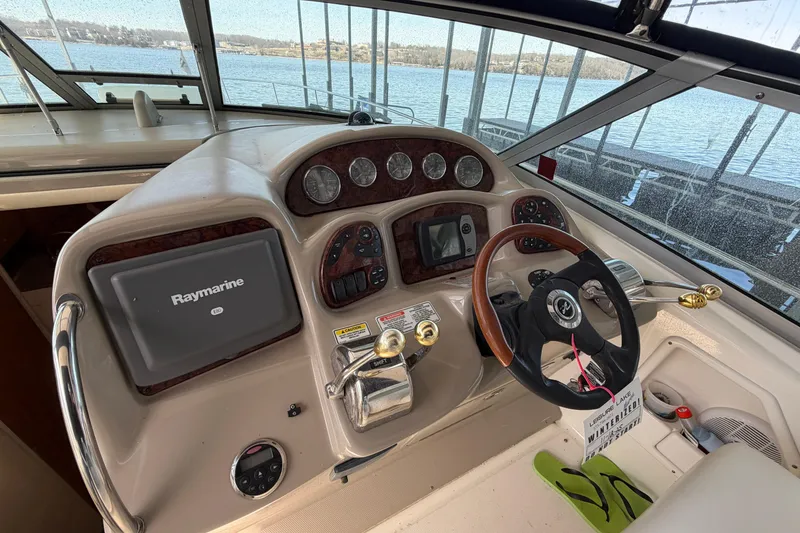 Slide: The Image of 2006 Sea Ray 340 Sundancer helm with Raymarine navigation system, overlooking marina. - 10