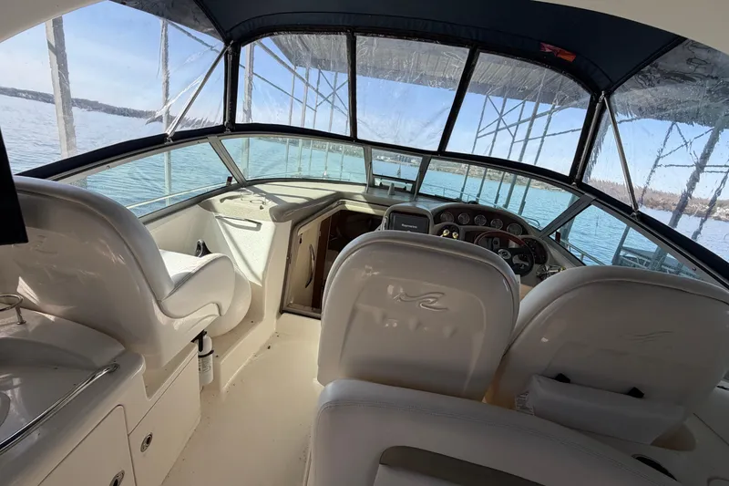 Slide: The Image of Interior view of 2006 Sea Ray 340 Sundancer boat cockpit with steering and seating. - 11