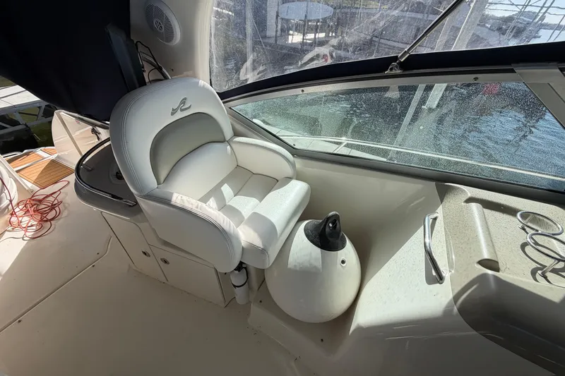 Slide: The Image of Captain's seat on 2006 Sea Ray 340 Sundancer boat, with helm and window view. - 12