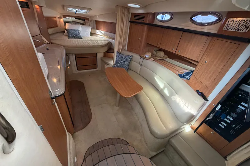 Slide: The Image of Interior of 2006 Sea Ray 340 Sundancer yacht with cozy seating and wooden cabinetry. - 14