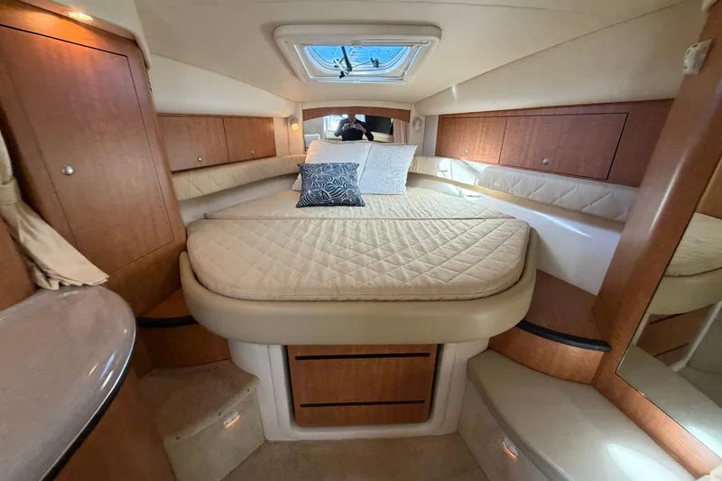 Slide: The Image of Luxurious cabin interior of 2006 Sea Ray 340 Sundancer yacht with cozy bedding. - 15