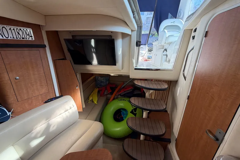 Slide: The Image of Interior of 2006 Sea Ray 340 Sundancer with seating, TV, and storage space. - 20