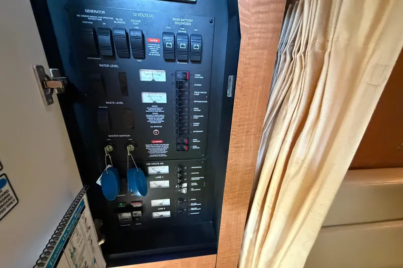Slide: The Image of Electrical panel inside 2006 Sea Ray 340 Sundancer boat cabin with switches and keys. - 21