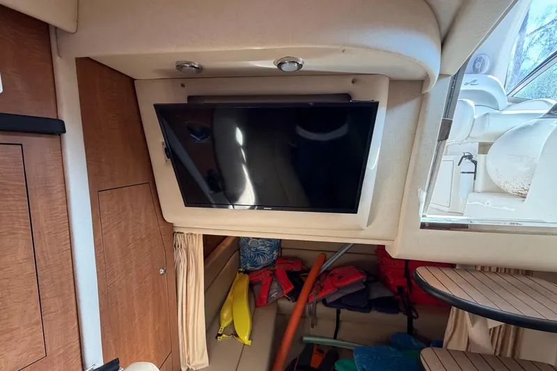 Slide: The Image of Interior of 2006 Sea Ray 340 Sundancer with mounted TV and storage area. - 22