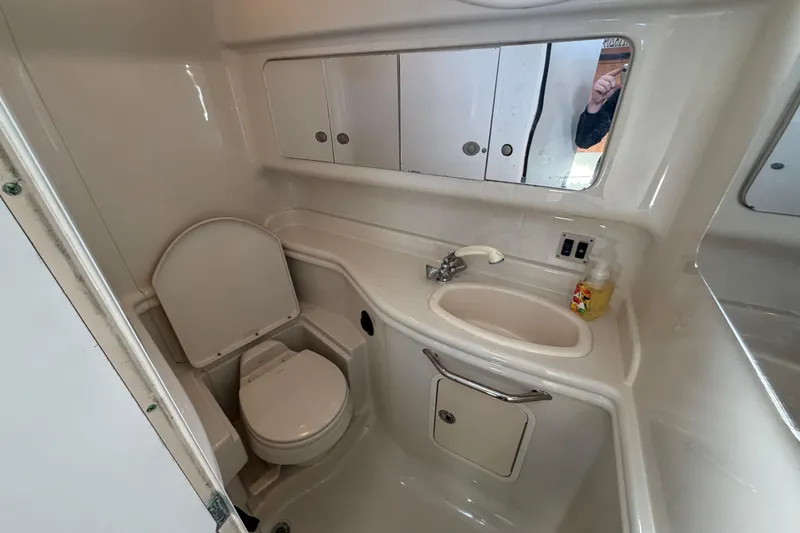 Slide: The Image of Bathroom interior of 2006 Sea Ray 340 Sundancer yacht, featuring sink and toilet. - 23