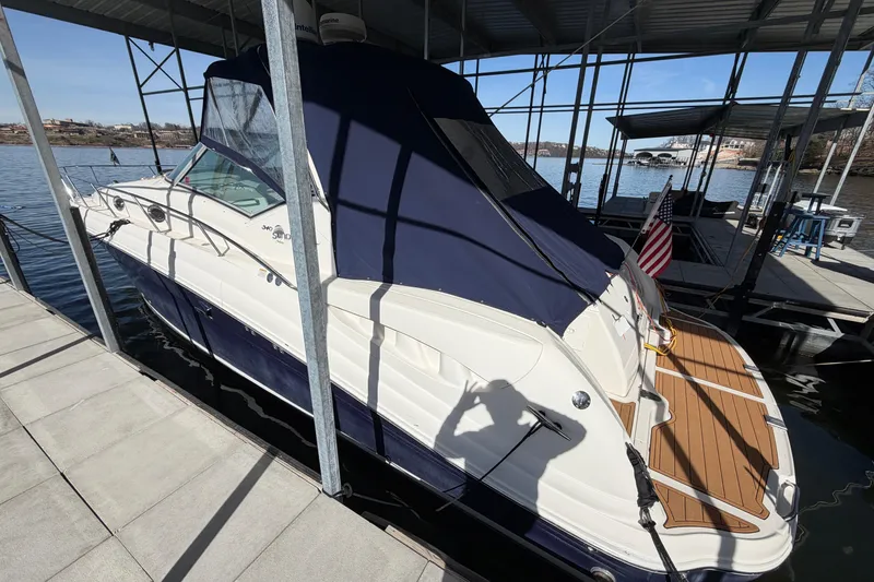 Slide: The Image of 2006 Sea Ray 340 Sundancer docked, featuring sleek design and covered cockpit. - 6