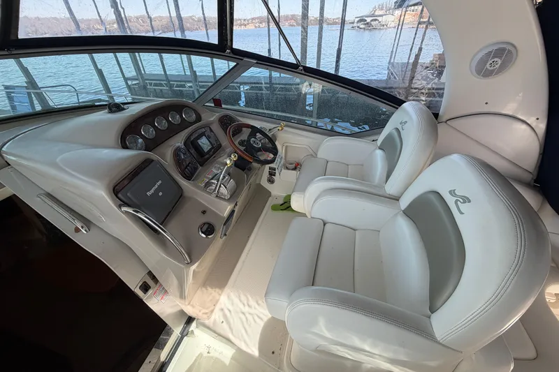 Slide: The Image of Interior cockpit of 2006 Sea Ray 340 Sundancer boat with steering wheel and controls. - 9