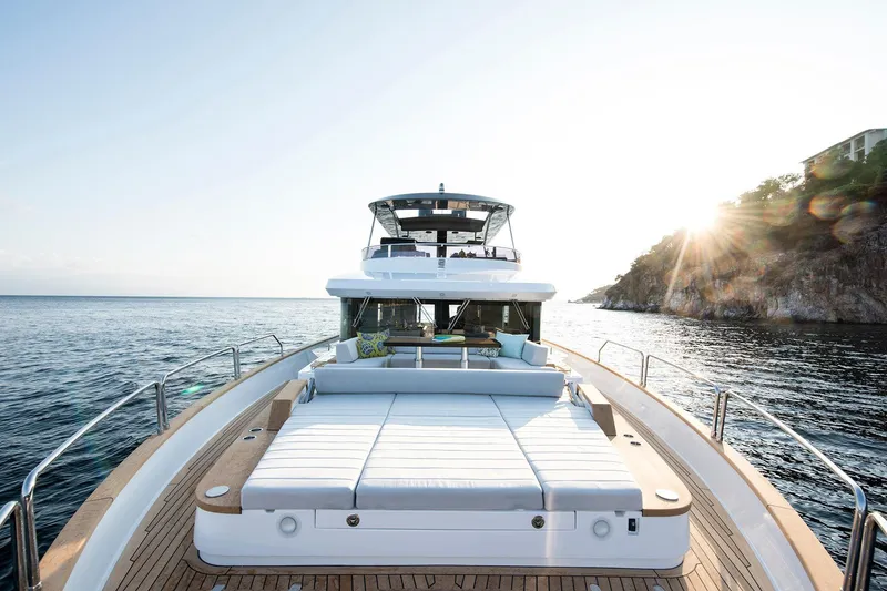 Slide: The Image of Luxurious Sirena 68 yacht cruising near rocky coastline at sunset, 2026 model. - 16