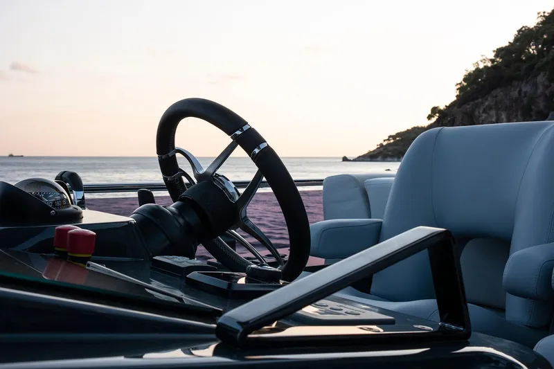 Slide: The Image of Cockpit of 2026 Sirena 68 yacht at sunset, featuring steering wheel and controls. - 24