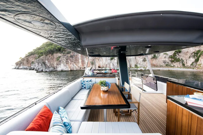 Slide: The Image of Luxurious Sirena 68 yacht deck with elegant seating and scenic coastal view, 2026 model. - 26