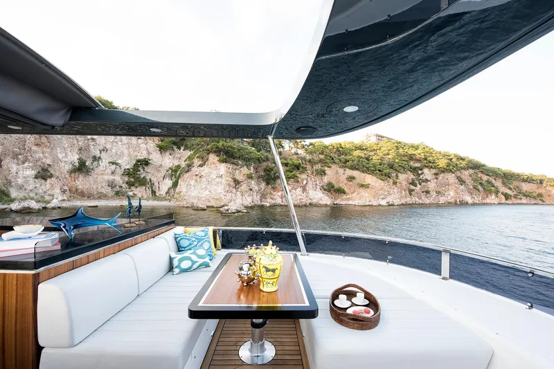 Slide: The Image of Luxurious Sirena 68 yacht deck with elegant seating, scenic coastal view, 2026 model. - 28