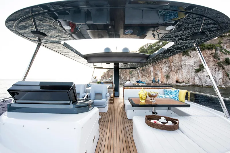 Slide: The Image of Luxurious 2026 Sirena 68 yacht deck with elegant seating and scenic coastal view. - 29
