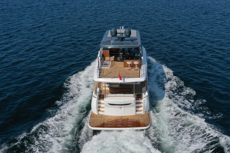 Slide: The Image of 2026 Sirena 68 yacht cruising on open sea, rear view. - 3