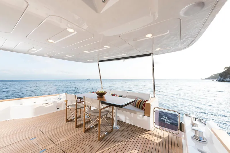 Slide: The Image of Luxurious Sirena 68 yacht deck with seating, table, and ocean view, 2026 model. - 31