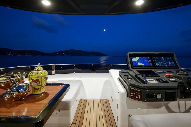 Slide: The Image of Luxurious Sirena 68 yacht helm at night, featuring elegant decor and advanced navigation systems. - 39