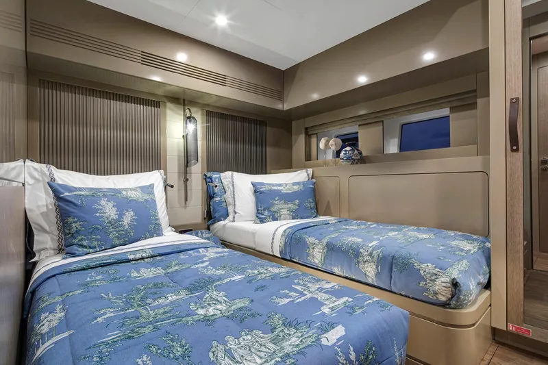 Slide: The Image of Luxurious twin bedroom in 2026 Sirena 68 yacht with elegant blue bedding. - 75