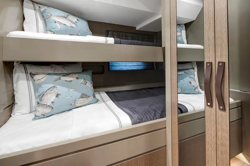 Slide: The Image of Bunk beds with fish-themed pillows in 2026 Sirena 68 yacht cabin. - 76