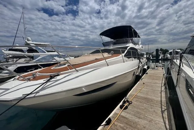 Slide: The Image of 2008 Azimut 47 yacht docked at marina under cloudy sky. - 10