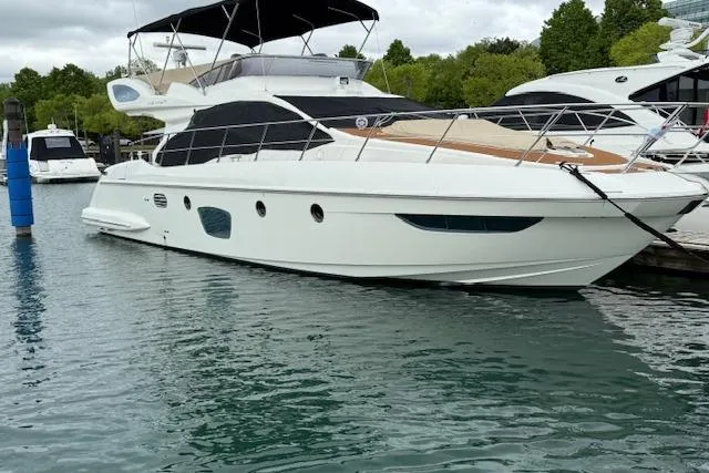 Slide: The Image of 2008 Azimut 47 yacht docked in a marina, featuring sleek design and modern amenities. - 11