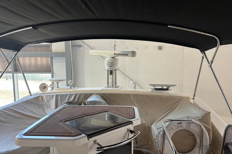 Slide: The Image of Interior view of 2008 Azimut 47 yacht with covered seating and navigation equipment. - 13