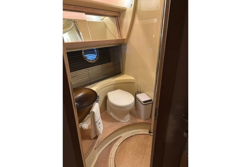 Slide: The Image of Luxurious bathroom in 2008 Azimut 47 yacht with modern fixtures and porthole window. - 15