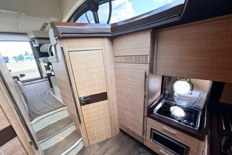 Slide: The Image of Interior of 2008 Azimut 47 yacht featuring modern kitchen and cozy living space. - 22