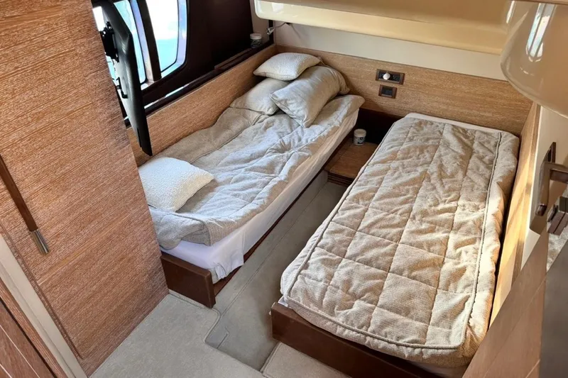 Slide: The Image of Cozy twin cabin in 2008 Azimut 47 yacht with plush bedding and wooden accents. - 23
