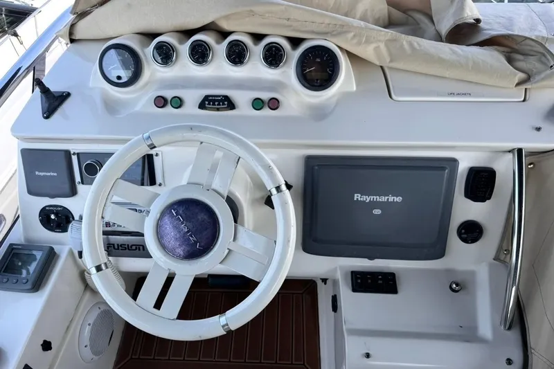Slide: The Image of Cockpit of 2008 Azimut 47 yacht with steering wheel and Raymarine navigation system. - 25