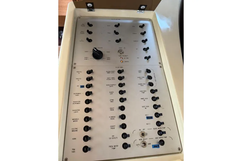 Slide: The Image of Control panel of a 2008 Azimut 47 yacht with various switches and dials. - 27