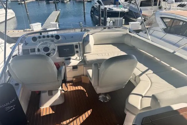 Slide: The Image of 2008 Azimut 47 yacht interior with helm, seating, and marina view. - 4