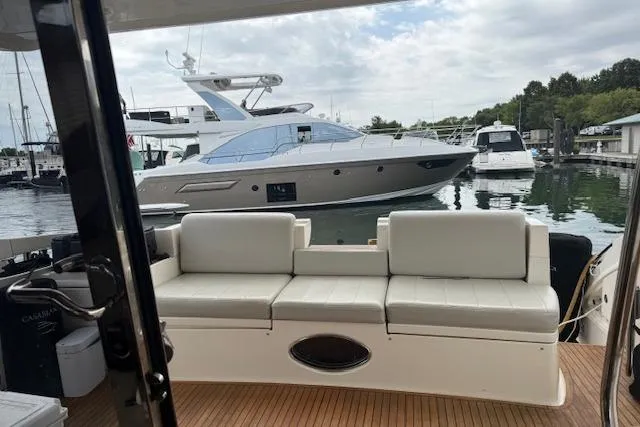 Slide: The Image of Luxury yacht Azimut 47, 2008 model, docked at marina with plush seating. - 8