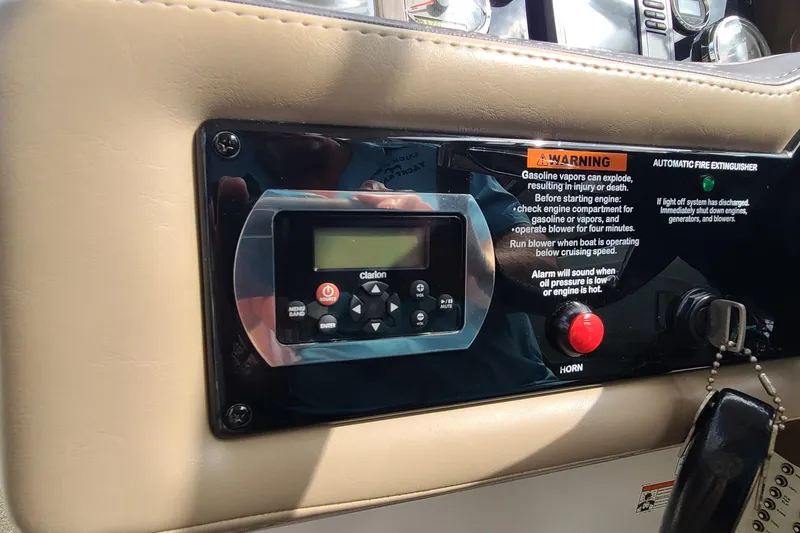 Slide: The Image of Control panel of a 2015 Formula 270 Bowrider with warning labels and Clarion audio system. - 10