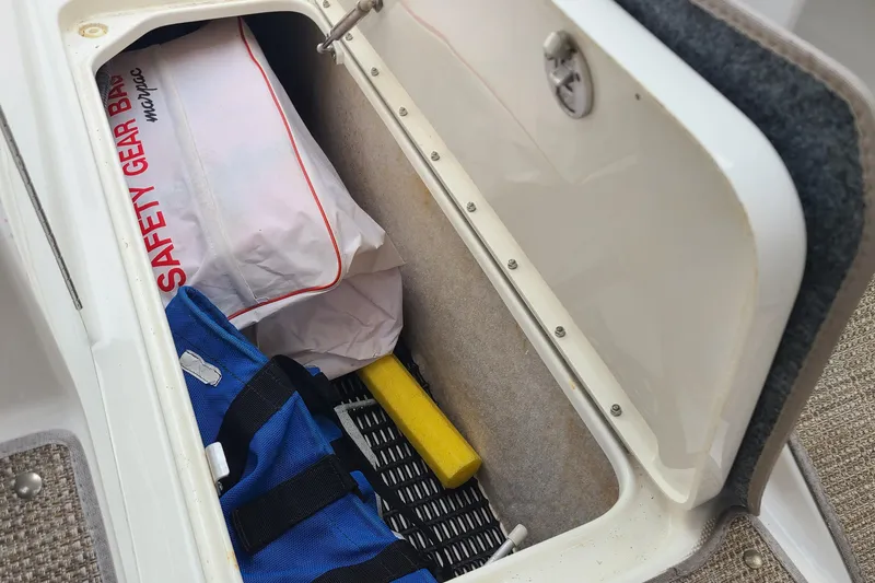 Slide: The Image of Storage compartment in a 2015 Formula 270 Bowrider with safety gear and equipment. - 14