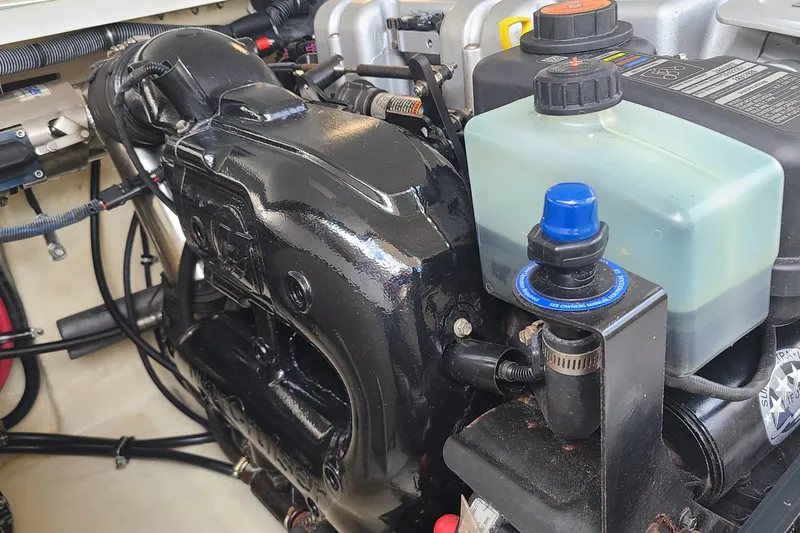 Slide: The Image of Engine compartment of a 2015 Formula 270 Bowrider boat, showcasing mechanical components. - 19