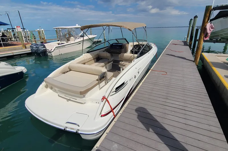 Slide: The Image of 2015 Formula 270 Bowrider docked at marina under clear skies. - 2