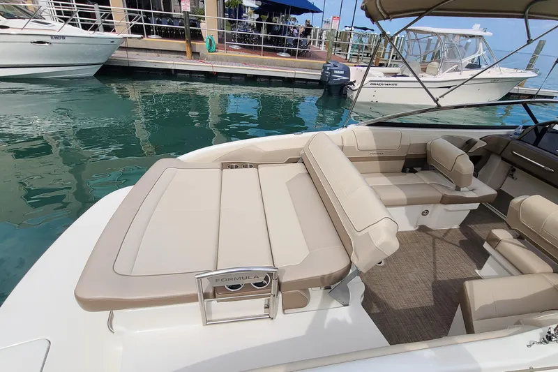 Slide: The Image of 2015 Formula 270 Bowrider boat with beige seating, docked at marina. - 24