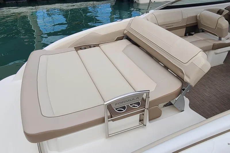 Slide: The Image of 2015 Formula 270 Bowrider boat interior with beige seating and cup holders. - 25