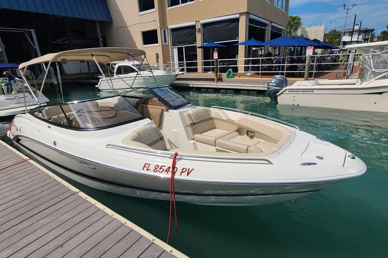 Slide: The Image of 2015 Formula 270 Bowrider docked at marina, featuring sleek design and spacious seating. - 3
