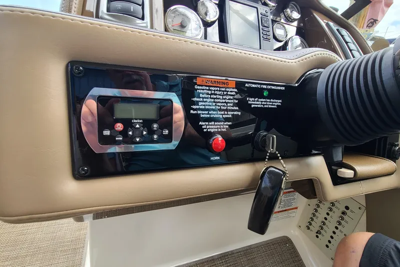 Slide: The Image of Dashboard of a 2015 Formula 270 Bowrider boat with control panel and warning labels. - 8