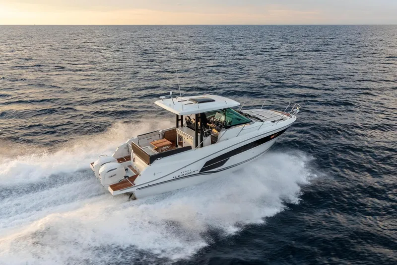 Slide: The Image of 2027 Jeanneau Leader 10.5 WA Series 2 cruising on open sea at sunset. - 2