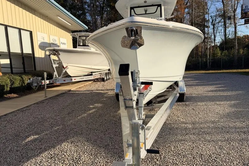 Slide: The Image of 2025 Sea Hunt Ultra 255 SE boat on trailer, parked outdoors. - 3