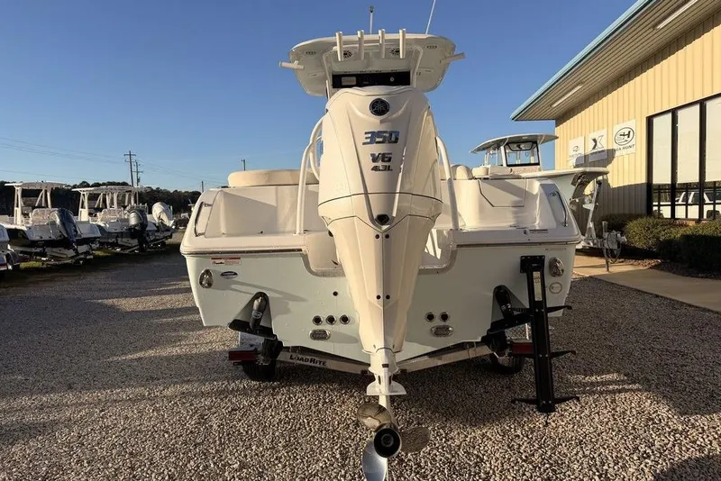 Slide: The Image of 2025 Sea Hunt Ultra 255 SE boat with powerful outboard motor, displayed outdoors. - 4